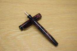 A Parker Duofold Junior button fill fountain pen in Burgundy and Black marble with two narrow cap