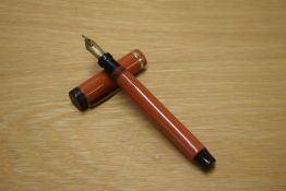 A Parker Duofold Senior Lucky Curve button fill Big Red fountain pen with single wide cap band