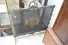 An ornate brass firescreen, late 19th or early 20th Century