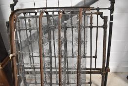 A vintage cast iron bed frame and sprung base