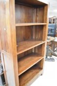 A modern hardwood bookshelf, having drawer base, dimensions approx. H190 W101 D40cm