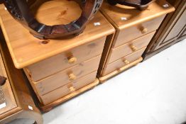 A pair of modern pine three drawer bedside chests
