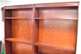 A pair of reproduction mahogany effect full height bookshelves