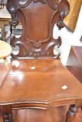 A Victorian mahogany hall chair having shield back