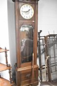 An early 20th Century oak cased long cased clock having silvered dial with Arabic numerals, and