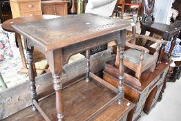 A late 19th or early 20th Century occasional table having carved top and turned legs, width