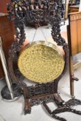 A traditional brass gong, diameter 50cm, having Oriental hardwood frame