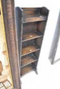 A late 19th or early 20th Century oak narrow bookshelf