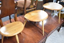 A nest of three Ercol pebble style tables, width approx. 65cm