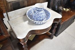 A 19th Century mahogany framed wash stand having shaped marble top , with recess for matched wash