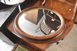 A modern mahogany oval wall mirror, approx. 59 x 48cm