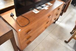 A vintage teak chest or small sideboard having three long by three short drawers, width approx.