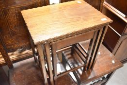 A nest of three mahogany tables having shaped edge and fine legs