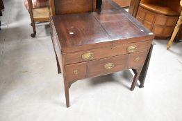 A 19th Century Regency design mahogany fold out washstand having mirror and compartmental