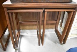 A vintage teak nest having fold out top, by Mcintosh