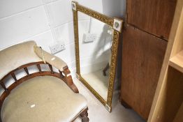 A vintage gilt wall mirror having tile decoration to corners, approx. 88 x 62cm