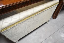 A vintage woven fibre style ottoman