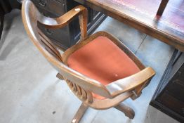 An early 20th Century oak framed swivel office chair