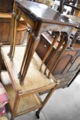 A reproduction nest of three table and a vintage oak tea trolley
