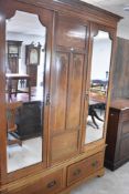 An Edwardian mahogany mirror and double door wardrobe