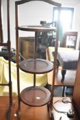An Edwardian mahogany folding cake stand