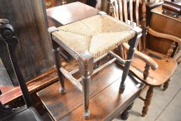 A 19th Century rush seated stool having turned frame