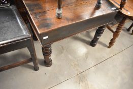 A Victorian side table with lid and interior ceramic porcelain bidet / baby bath, raised on turned
