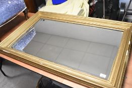 A large gilt plaster over mantel wall mirror, approx. 107 x 68cm