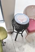 An Oriental style plant stand having rouge marble top, height approx. 77cm