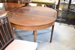 A George III mahogany dining table comprising D ends and central leaf