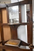 An early 20th Century oak hall stand, having Arts and Crafts style coat hooks, height approx. 200cm,
