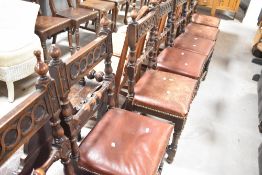 A set of seven Victorian semi gothic oak dining chairs having turned rails and additional carved and