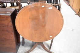 A reproduction regency style tilt top occasional table, diameter approx. 64cm
