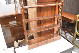A modern hardwood wall shelf of small proportions, width approx. 66cm