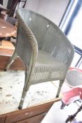 A vintage Lloyd Loom tub chair in green