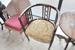 An Edwardian mahogany salon armchair