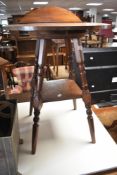 A Victorian and later occasional table , circular top having been adapted into ledge back, on turned