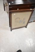 A vintage wood frame embroidery fire screen