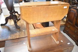 An Arts and Crafts golden oak drop leaf occasional table , most likely Arthur Simpson, having