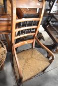 A 19th Century rush seated rocking chair having spindle back