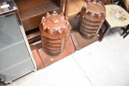 A pair of salt glazed ridge top bishop style chimney pots