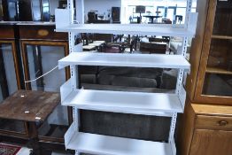 A set of free standing powder coated metal library shelves , width approx. 93cm