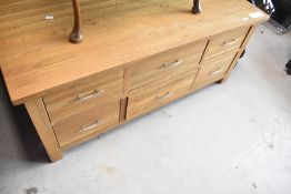 A modern gold oak coffee table having drawer storage below, approx. 116 x 58cm