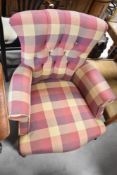 A Victorian style low seat nursing armchair having modern check upholstery