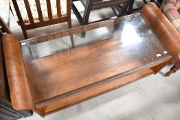 A vintage G plan teak and glass top coffee table in the tulip style, on castors, width approx. 121cm