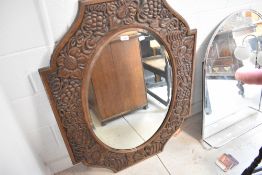 A carved oak wall mirror, having grapevine decoration, approx 82 x 106cm