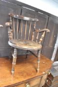 A late 19th or early 20th Century stained frame kitchen armchair