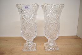 A pair of cut crystal tulip vases supported on a square base, h26cm