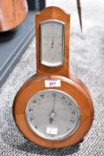 A vintage Art Deco barometer having additional information written onto the glass