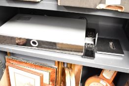 A Loewe digital blue ray CD player with remote and stand